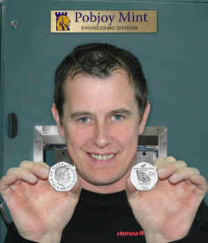 John McGuinness shows the coin struck by him